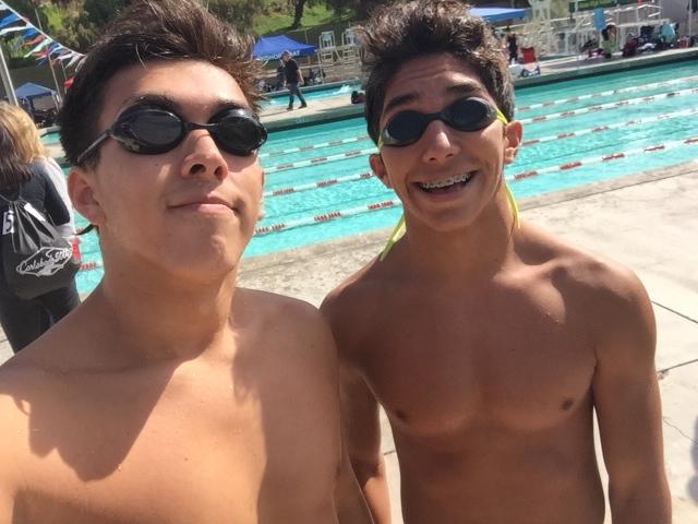 Seniors Zack Medina and Anthony Rosas smile for the camera during their last swim meet of their high school career. Ending high school sports is an emotional time because its the end of team bonds. There isnt gonna be a next time. 
