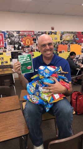 Mr. Grebel in his classroom showing off his jolly ranchers. Photo courtesy of Alyssa Gonzalez