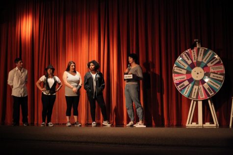 Team leaders (left to right) Jonathan, Dalia, Mikaela, and Olivia stand alongside MC Hailey. The four judges had to spin the wheel to determine what category they will perform. 