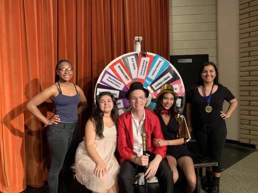 The host and the captains pose in front the wheel of categories they must perform to
Photo Creds: Anthony Romero