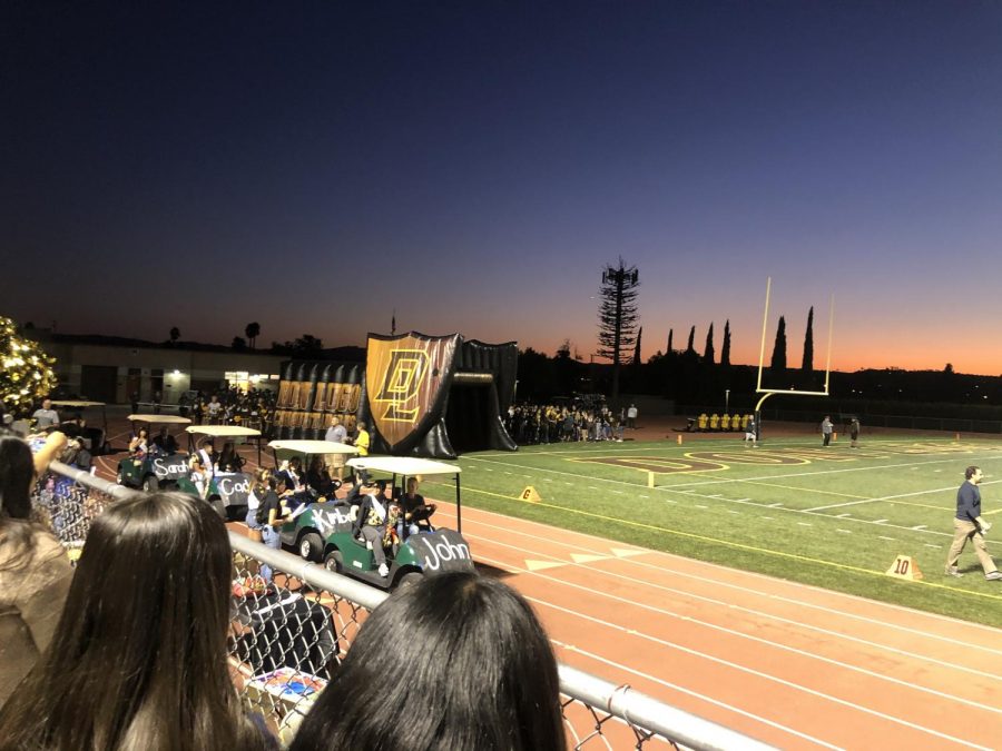 Don Lugo sports fans wait for the football players to make their entrance and run through the Don Lugo tunnel. The picture shows the Don Lugo tunnel beneath the sunset on the field at the homecoming football game.