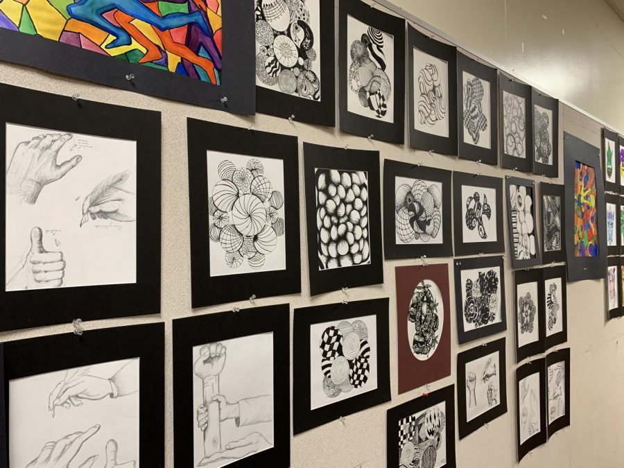 The wall of art pieces made by Ms. Lees advanced art students during their first semester. Showing that the beauty of art is unparalleled and truly important.