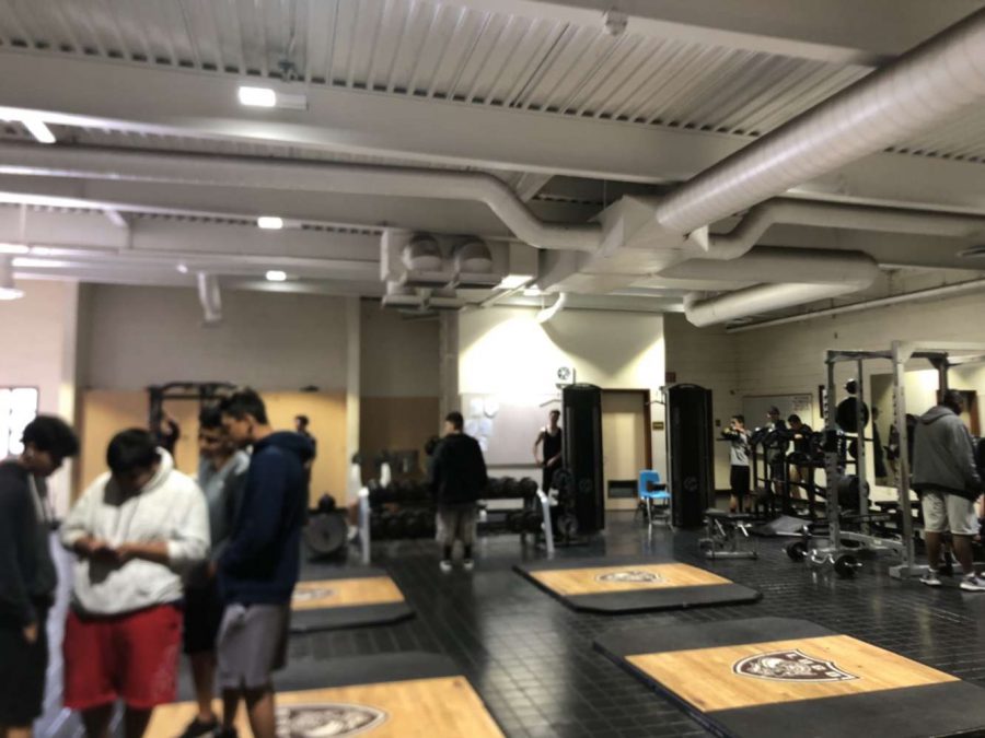 Athletes inside weight room during 4th period. During off-season football athletes make their improvement in the weight room.