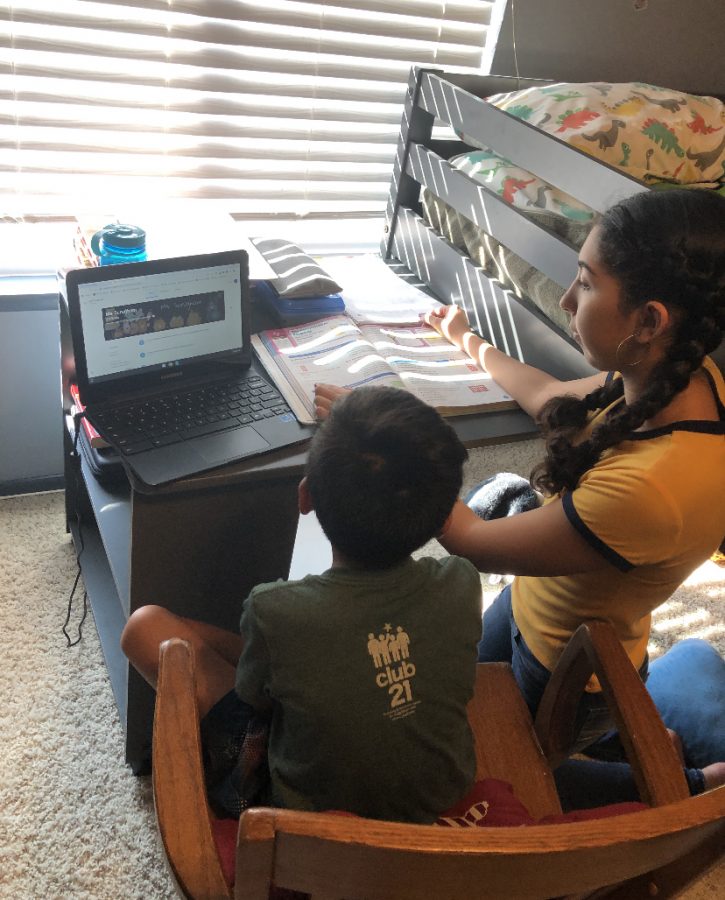 Jazmine Coto helping her 3rd grade brother with online learning. This shows an example of how older siblings have to help their younger sibling with their work which can cause confusion for both students as they continue to adapt to online learning together.