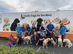 Guide Dogs For the Blind puppy trainers take picture in front of departure truck as the dogs are being sent to training in San Rafael, California. Each puppy will be evaluated within the course of a few months on their effectiveness of being a guide dog and take on tasks in real-life situations that people who are blind will encounter.