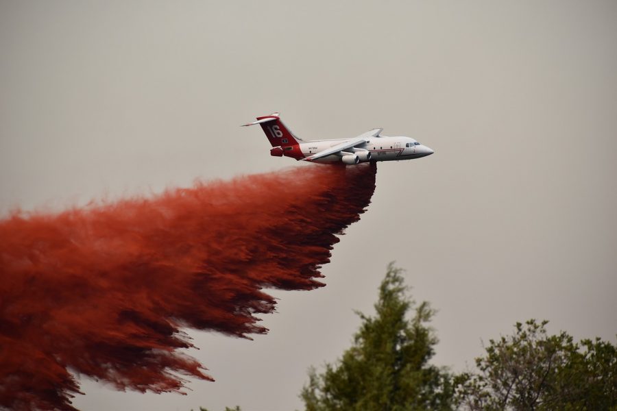 Airplane releasing red flame retardant on fire on the hills. (Photo Courtesy of Pixabay.com)