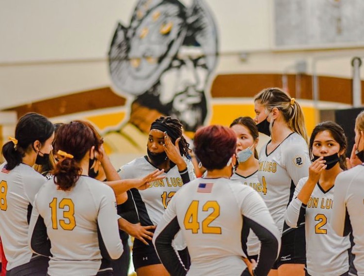 Don Lugo volleyball team huddles to find a solution to finish the game off with a win. This season the girls have been working harder to stay on their feet. 