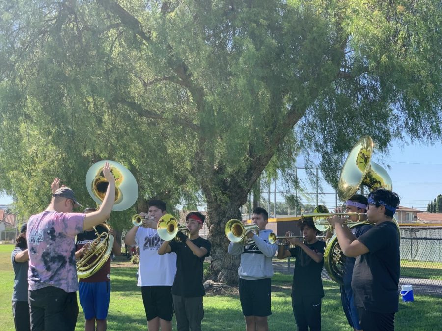 Band instructor, Mr. Yanik leads band students in breathing and marching exercises. We work hard and move forward to bring our best, said Mr. Yanik.