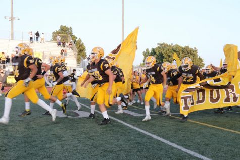 Don Lugos varsity football team is running out of the tunnel at a gameYou  cant coach effort, and the players got to make the plays, Coach Kim said.