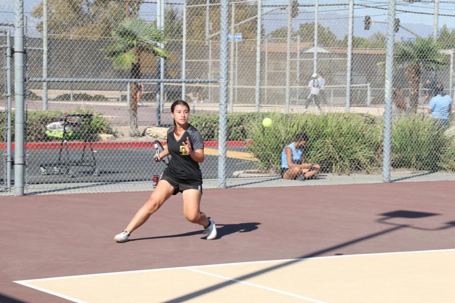 Captain Isabella Angon getting ready to hit a tennis ball to the other side of the court in a match against Montclair. Its just something about sports that I really love, said Isabella.