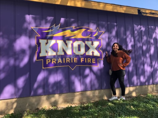 Adrie Villa is standing in front of Knox College while visiting the campus. Adrie had recently applied to this college along with one of their scholarship programs. 