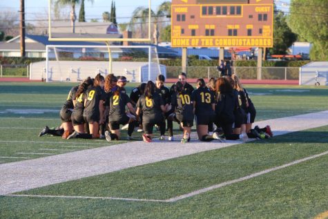 The Don Lugo Girls Varsity Soccer team is  doing their daily prayer before the big game, We have a strong offense and defense that can get us far says Coach Swift.