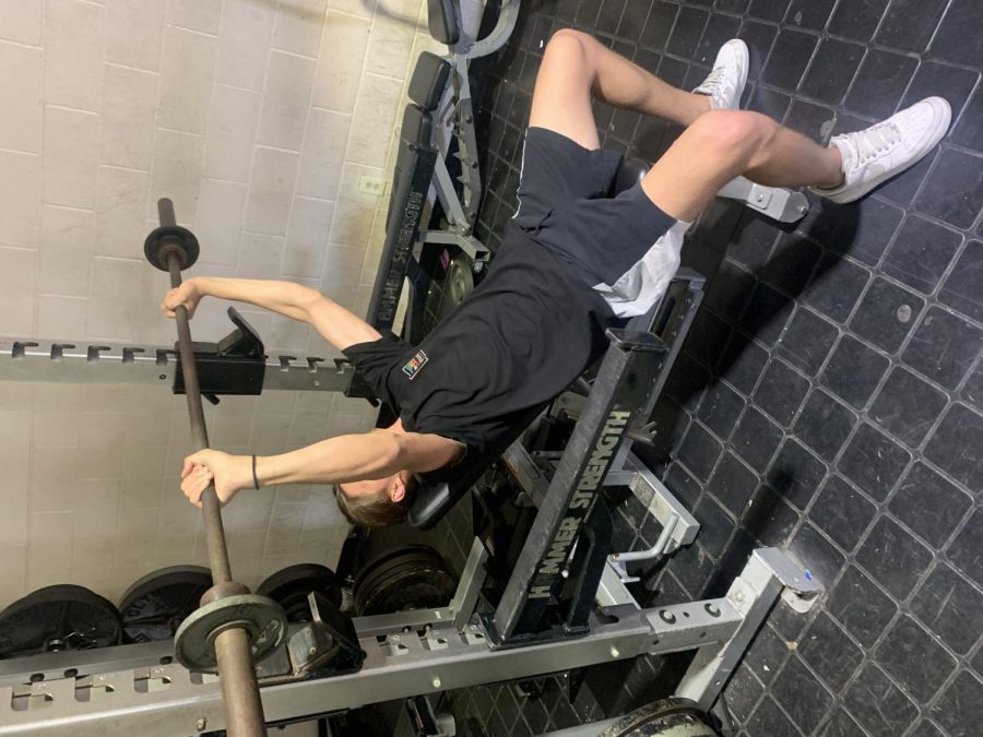 Luke Kemble, an out of season football and basketball player is in the weight room bench pressing during his off-season. 