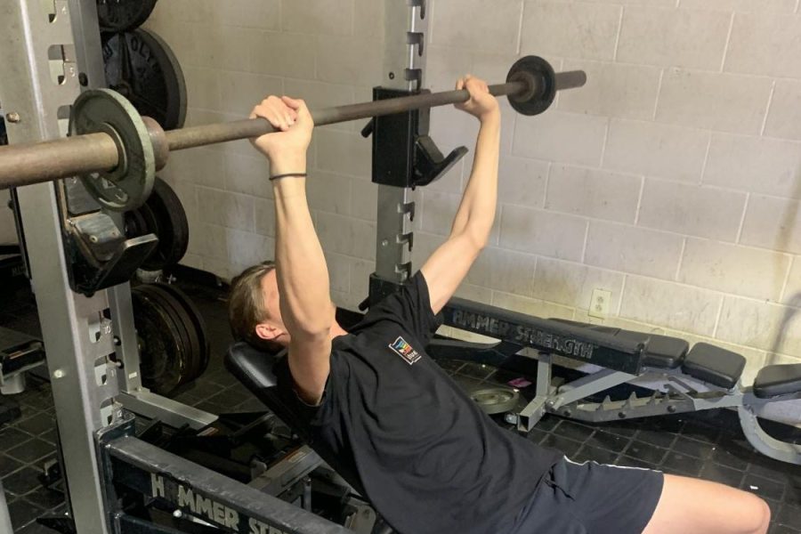 Luke Kemble, an out of season football and basketball player is in the weight room bench pressing during his off-season. 