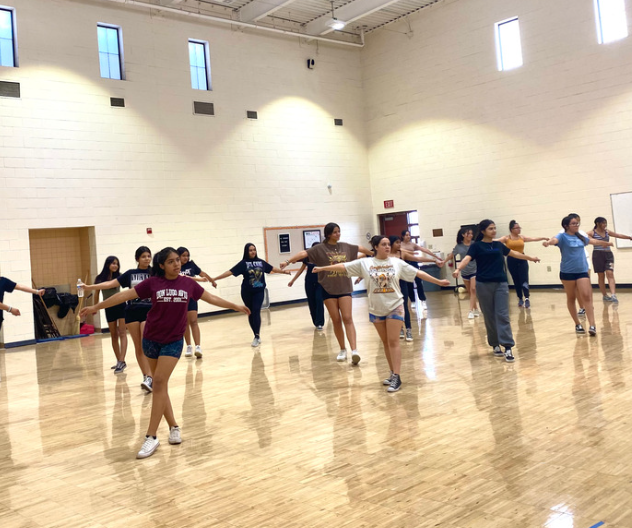 Don Lugo's hip hop team rehearsing the first routine they learned this year in the spirit room.