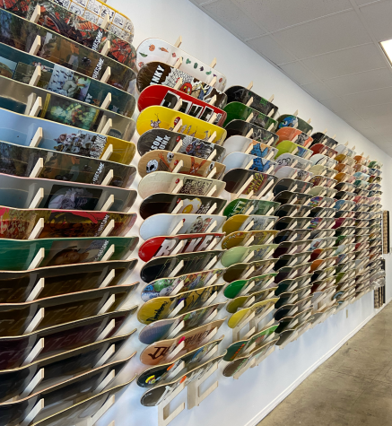 Wall of different skate decks available in the shop.