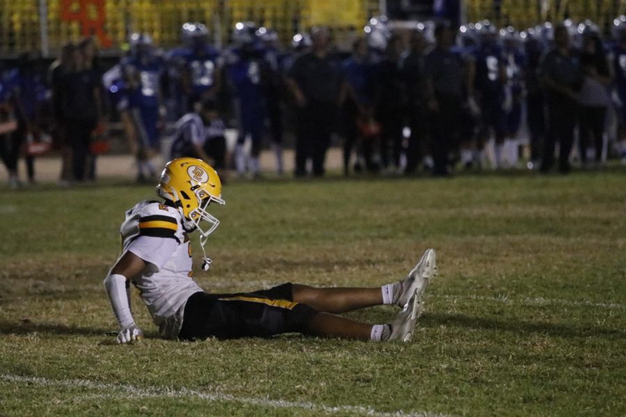 One of our football players sitting on the floor after a hard hit.