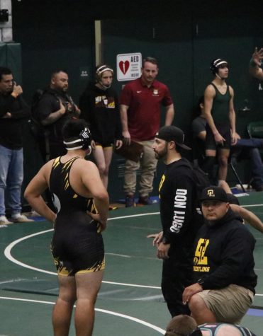 Coach Malouf talking to one of our wrestlers before a match