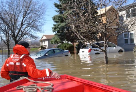 Coast Guard Officer Todd George wades through a flooded area as part of disaster assistance.
Image by the U.S. Coast Guard