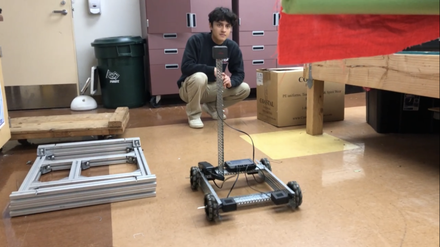 Photo by Artemis Statler. Josue and Jayzee(out of frame) test their engineering project during a robotics meeting. 