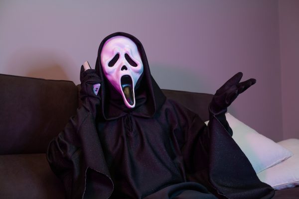 The signature costume  of Ghostface from the movie franchise Scream.
